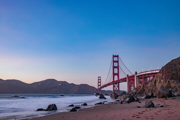 golden gate bridge at sunset from beach view.