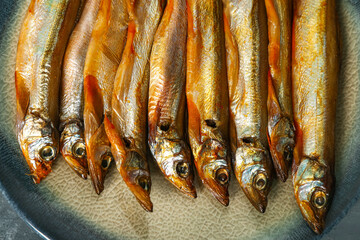 Plate with delicious smoked capelin, closeup