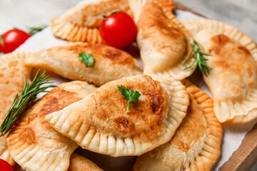 Board with tasty meat empanadas, closeup