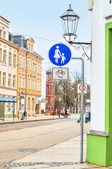 Road signs for pedestrians and cyclists on city street