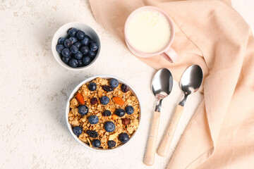 Tasty breakfast with granola on light background