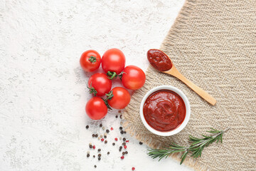 Napkin with bowl and spoon of tasty tomato paste on white grunge background