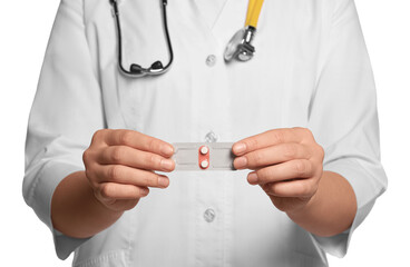 Doctor holding blister of emergency contraception pills against white background, focus on hands