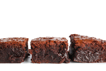 Pieces of tasty chocolate brownie isolated on white background, closeup