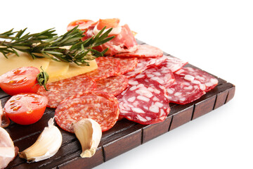 Wooden board with assortment of tasty deli meats isolated on white background, closeup