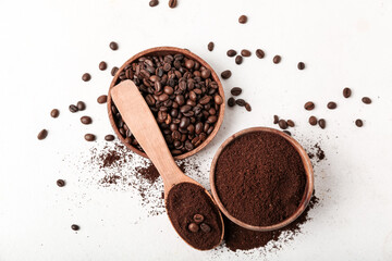 Spoon with bowls of coffee powder and beans on white background