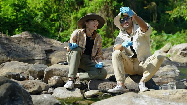 Biologist collecting natural water samples for research, environmental conservation concept, research, nature, carbon foot print, green
