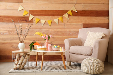 Interior of living room decorated for Easter celebration with armchair and tables
