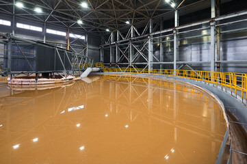 Huge container to separate liquid pulp material in workshop