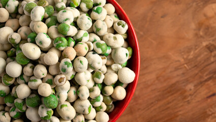 A Bowl of Green Wasabi Peas on a Table