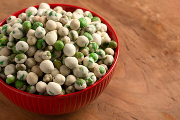 A Bowl of Green Wasabi Peas on a Table
