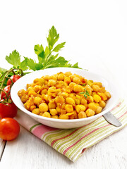 Chickpeas with vegetables stewed in plate on light board