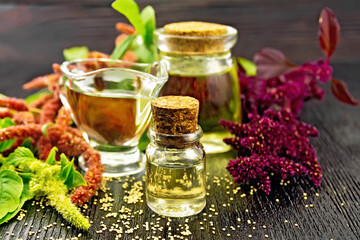 Oil amaranth in vial on wooden table