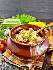 Rice with chicken and vegetables in pot on towel