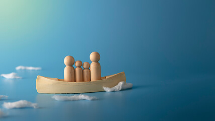 Teamwork and courage concept. Wooden boat on blue background.