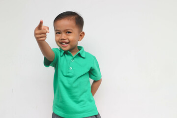 Portrait of a happy little Asian boy smiling while pointing , isolated on the white background