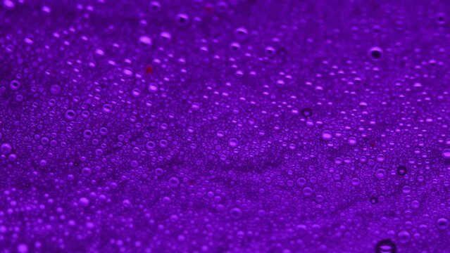 Abstract made by mixing oil, water and soap back lite with colored strobe light.