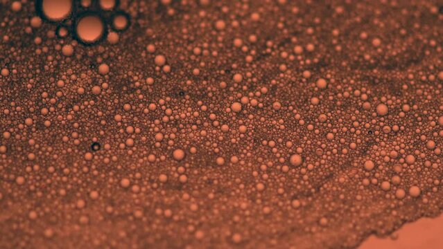 Abstract made by mixing oil, water and soap back lite with colored strobe light.