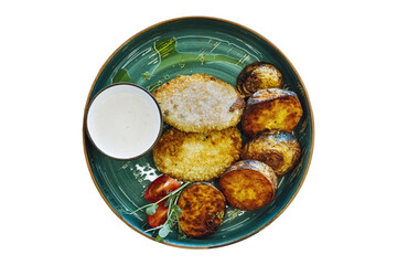 fish cutlets with baked potatoes and white sauce. isolated. view from above.