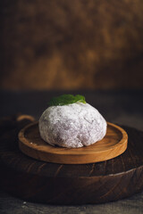 Japanese mochi or rice cake filled with red bean and strawberry, mint leaves on top. Japan traditional rice cake.