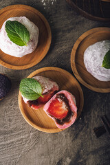 Japanese mochi or rice cake filled with red bean and strawberry, mint leaves on top. Japan traditional rice cake.