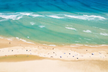 Looking down on a populated beach of swimmers