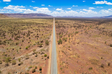 Aerial view of remote asphalt road that curves in the distance in the Australian outback