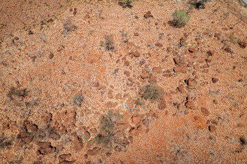 Looking down at the stony texture below with the red dirt of Australian’s outback.