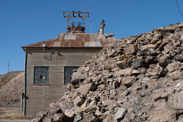 Headframe and buildings at old mining site in Broken Hill, NSW, Australia. This area of Broken Hill is where the mining company BHP was founded in 1885. They mined silver, lead and zinc.
