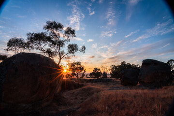 Sun setting behind boulders in outback Australia