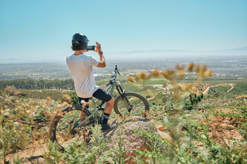 Cycling, fitness and man on a bicycle with phone for picture, photography or photo in nature....