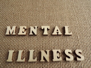mental illness wooden letters and figurines of men and women