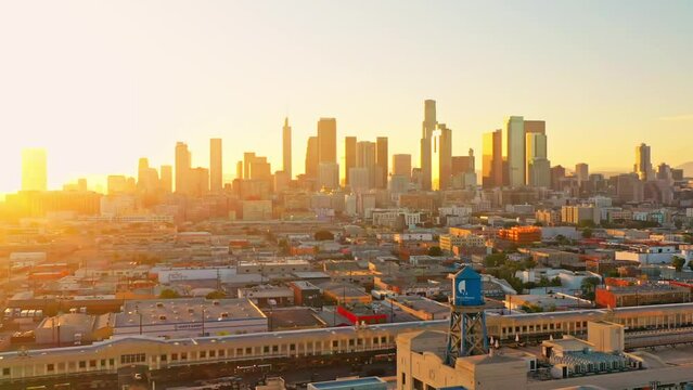 Los Angeles, LA skyline in golden sunset, aerial forward panorama flight