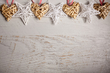 Christmas stars and hearts decorations on white wooden background