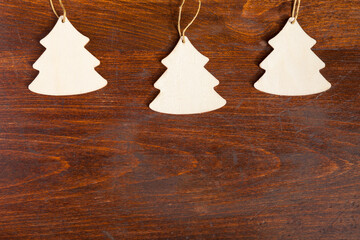 Three wooden tree on wooden background. Xmas decoration