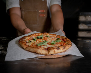 Margherita Italian pizza with melted mozzarella cheese and tomato.