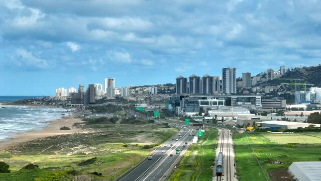 Southern entrance to Haifa in Israel north district, with city buildings and The Mediterranean Sea coastline