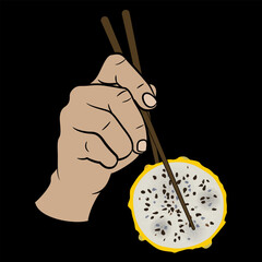 Human hand holding a round slice of Yellow Dragon Fruit with chopsticks. Pitaya or Pitahaya cactus. Selenicereus megalanthus. Exotic food design. On black background.