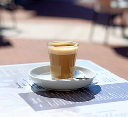 A latte on the table of a summer terrace