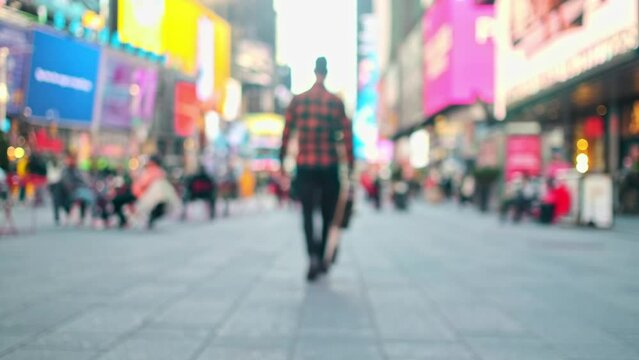 Musician is walking off into the distance holding a guitar in New York city