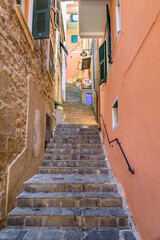 Steep narrow stone stairs on a street in Manarola, Cinque Terre, Italy