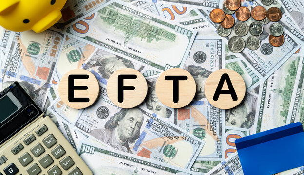 EFTA text in wooden circle on Banknotes background, credit card, piggybank, calculator. European Free Trade Association planning goals, opportunity, Budget, business strategy and financial concept.