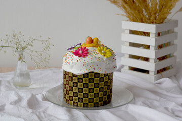 Easter cake. On a light background. On the table with dried flowers. Close-up. Selective focus....