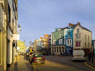 Fototapeta na wymiar Street in seaside town at late afternoon (Tenby, Wales, United Kingdom, in summer)