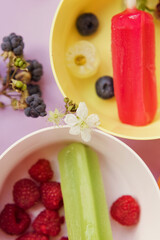 Colorful popsicles in bowls close up