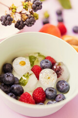 Ice cubes with berries and flowers