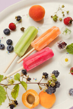 Colorful popsicles on tray close up