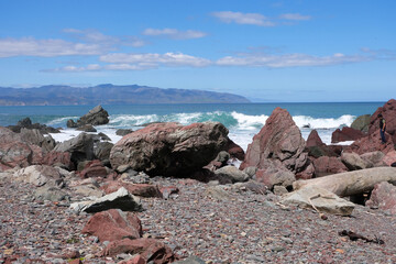 Wild rugged coastal landscape with red coloured rocks at Red Rocks on the South Coast of...