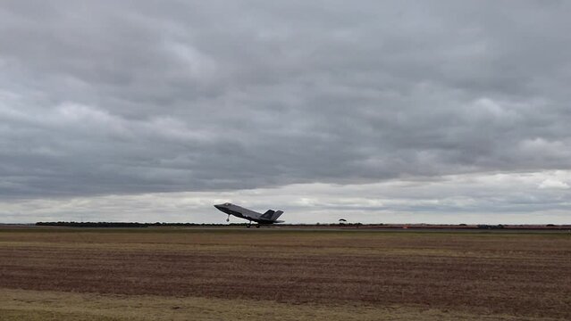F-35A Lightning II Jet Landed And Taxiing On The Airport Runway With Landing Gear On. tracking shot