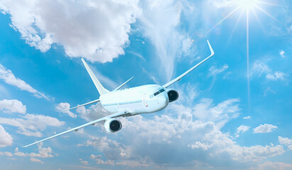 White passenger airplane flying in the sky amazing clouds in the background - Travel by air transport